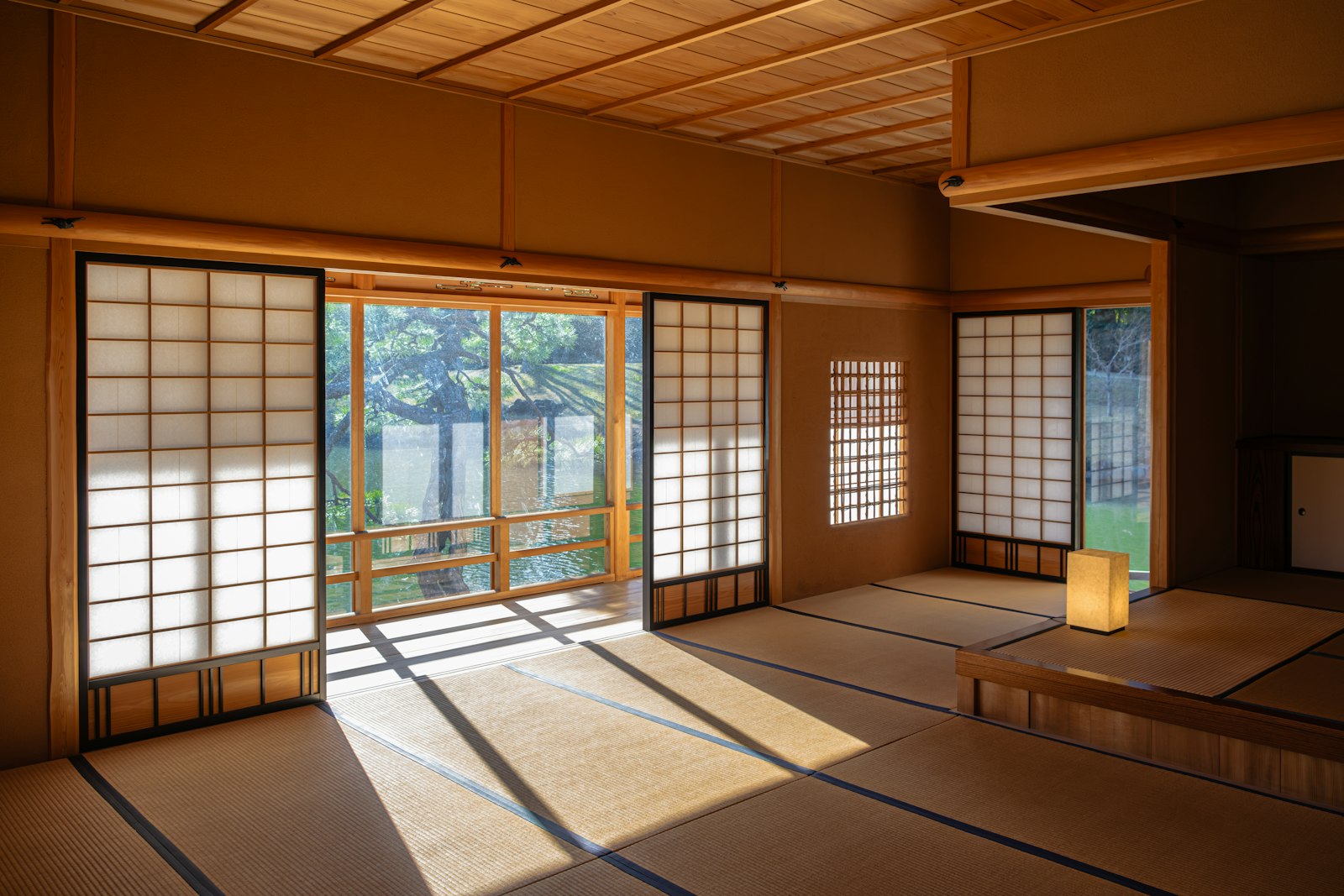 Traditional Japanese tatami room with shoji screens opening onto a garden